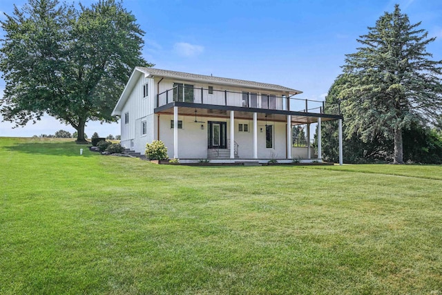 rear view of property featuring a yard