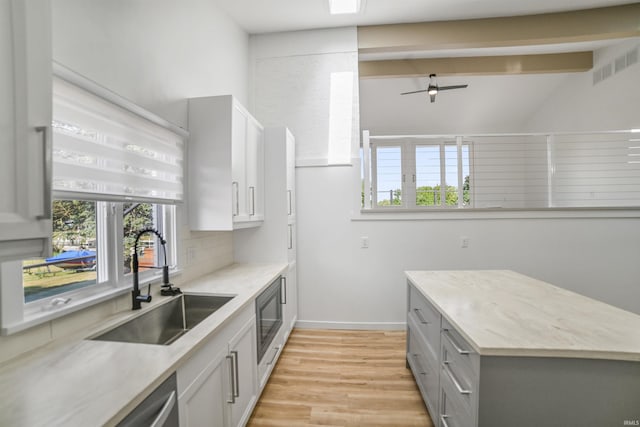 kitchen featuring a wealth of natural light, light wood-type flooring, sink, and ceiling fan