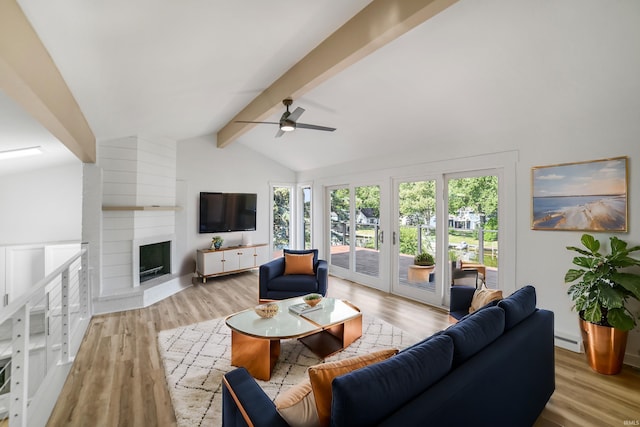 living room with light wood-type flooring, lofted ceiling with beams, ceiling fan, and a fireplace