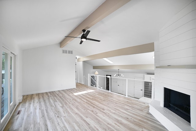 unfurnished living room with light wood-type flooring, vaulted ceiling with beams, ceiling fan, and a fireplace