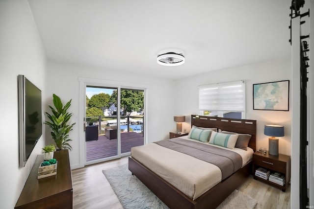 bedroom featuring access to exterior and light hardwood / wood-style floors