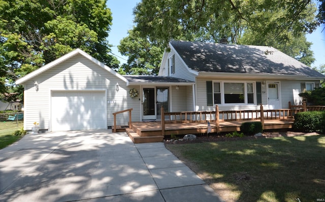 view of front facade with a front lawn, a wooden deck, and a garage