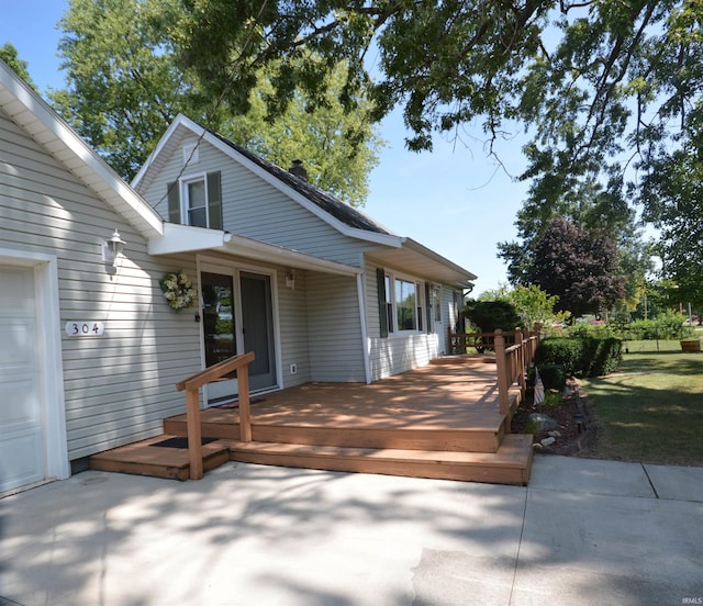 exterior space with a garage and a wooden deck