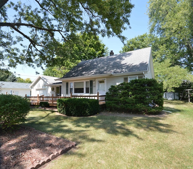 rear view of house with a deck and a yard