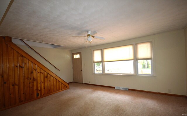 spare room featuring carpet floors and ceiling fan