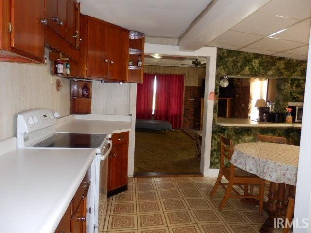 kitchen with light colored carpet and white electric range