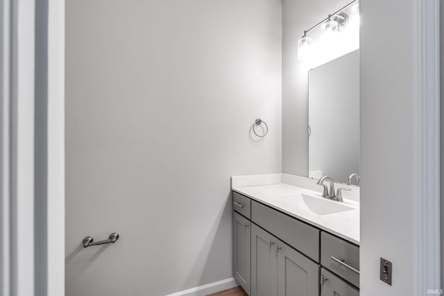 bathroom with vanity and baseboards