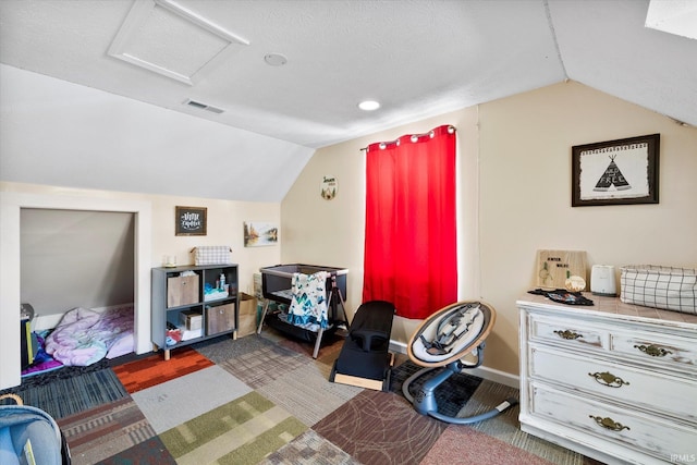 bedroom with vaulted ceiling and carpet