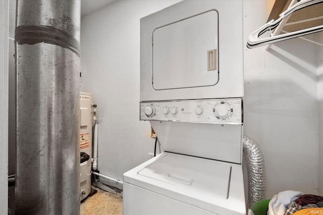 clothes washing area with stacked washing maching and dryer