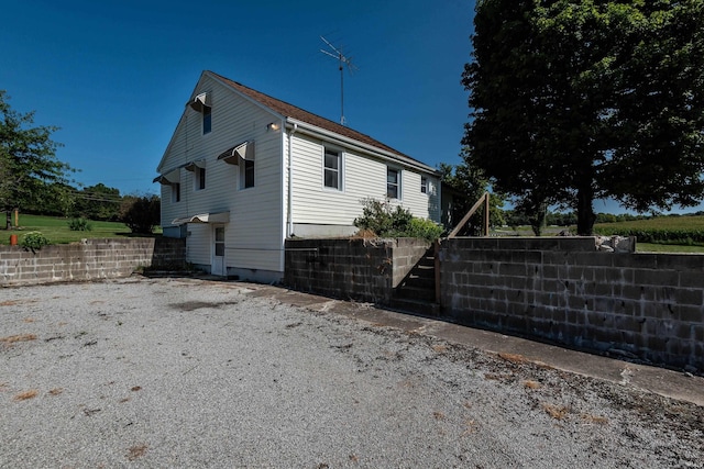 view of side of property featuring fence