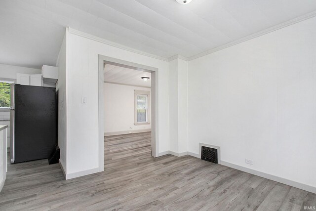 unfurnished room featuring light hardwood / wood-style flooring and ornamental molding