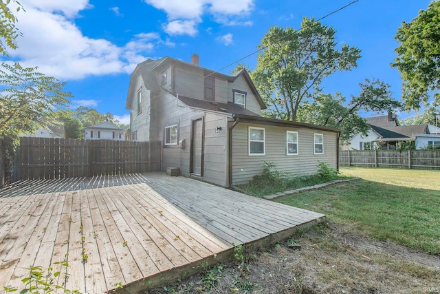 rear view of property with a yard and a deck