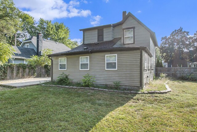 rear view of property with a patio area and a yard