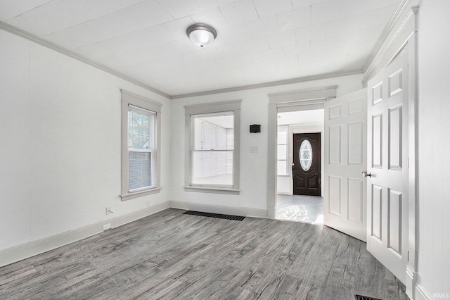 interior space with hardwood / wood-style floors and ornamental molding