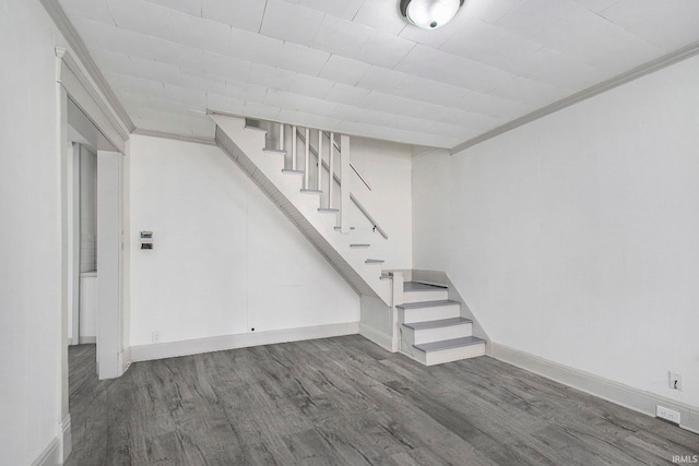 basement with hardwood / wood-style floors and ornamental molding