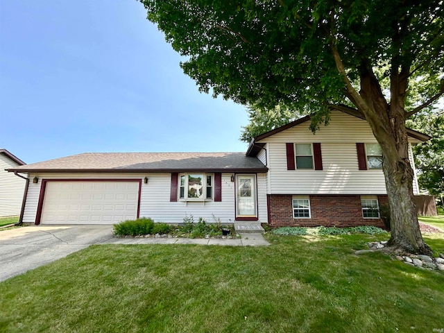 split level home with a front yard and a garage