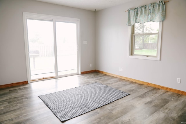 spare room featuring wood finished floors and baseboards