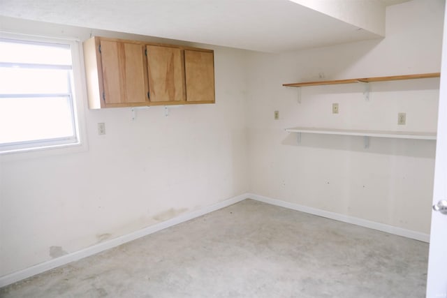 empty room with concrete flooring and baseboards