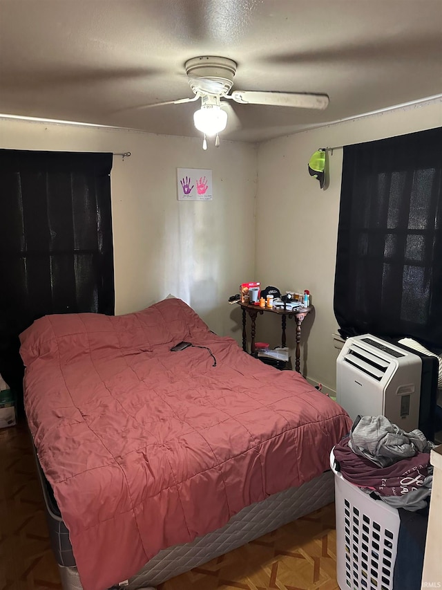 bedroom with parquet floors and ceiling fan