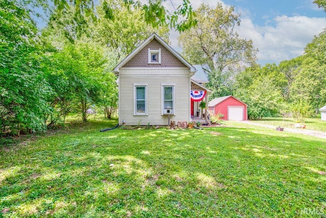 view of front of home with an outbuilding, a garage, and a front lawn