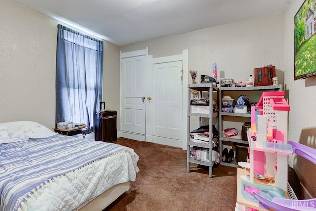 bedroom with carpet and a closet