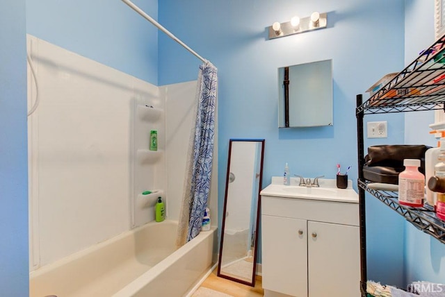 bathroom with shower / bath combination with curtain, hardwood / wood-style floors, and vanity