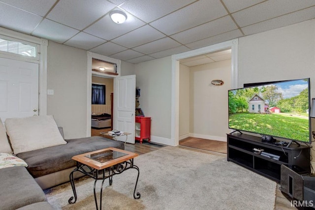 living room featuring a paneled ceiling and hardwood / wood-style flooring