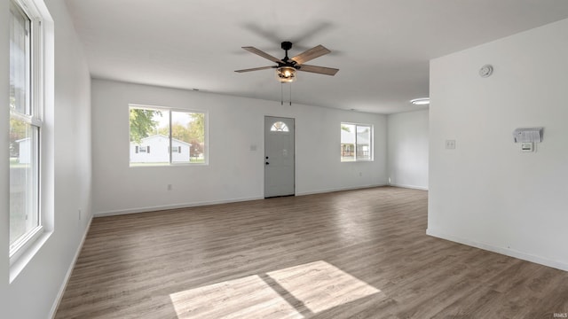 spare room featuring light wood-type flooring and ceiling fan