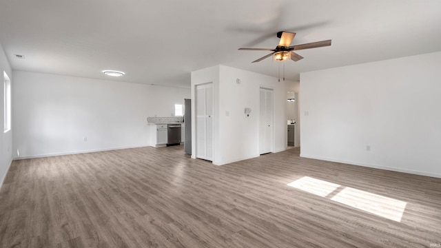 unfurnished living room with hardwood / wood-style flooring and ceiling fan