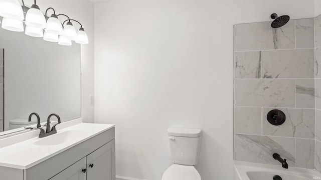 full bathroom with tiled shower / bath, vanity, and toilet