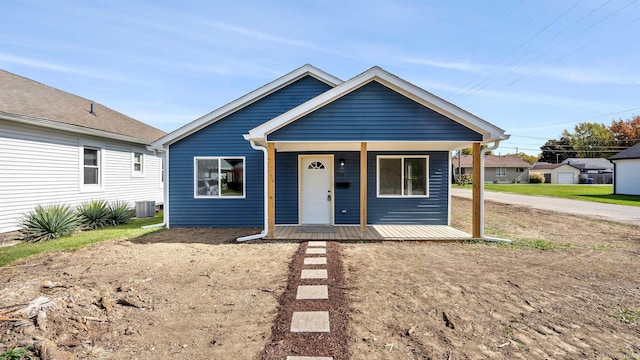 bungalow with a porch and cooling unit