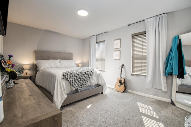 carpeted bedroom with baseboards