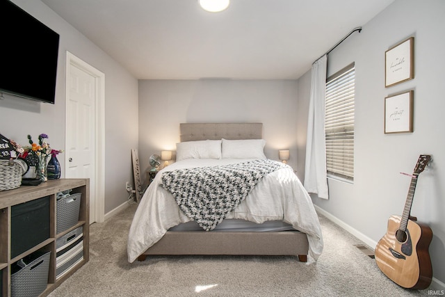 bedroom featuring carpet floors and baseboards