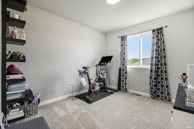 workout area with carpet flooring, visible vents, and baseboards