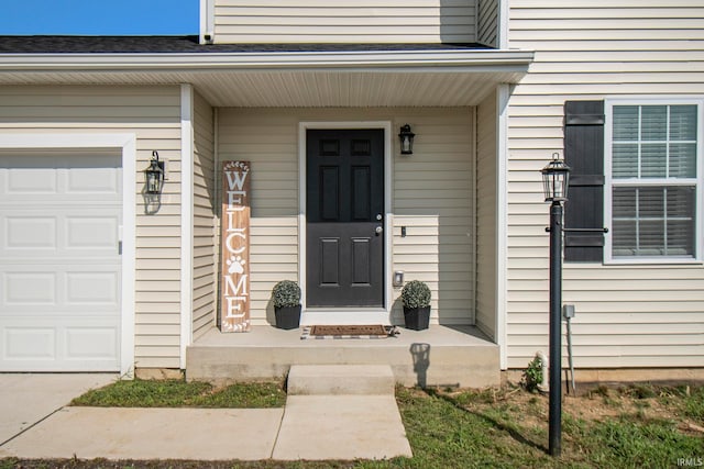 doorway to property with a garage