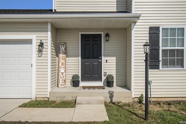 doorway to property with a garage