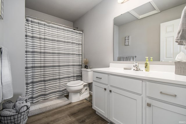 bathroom with toilet, a shower with shower curtain, wood finished floors, and vanity