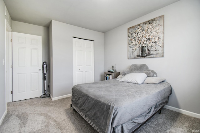 bedroom with a closet, baseboards, and carpet flooring