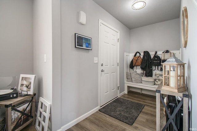 mudroom with dark wood-style floors and baseboards