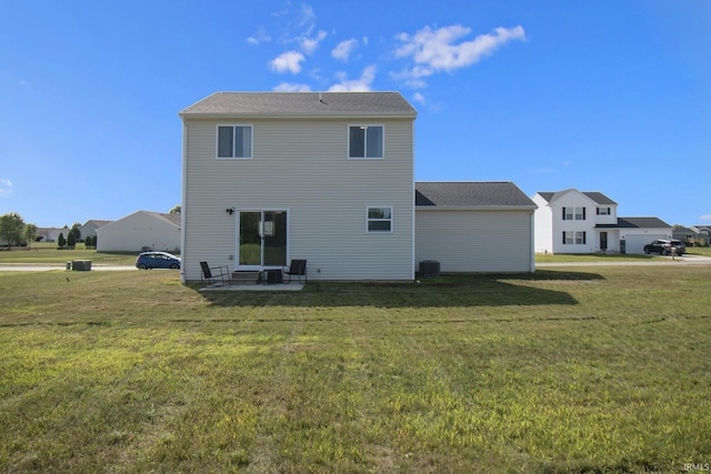 rear view of property featuring a yard, a residential view, and a patio