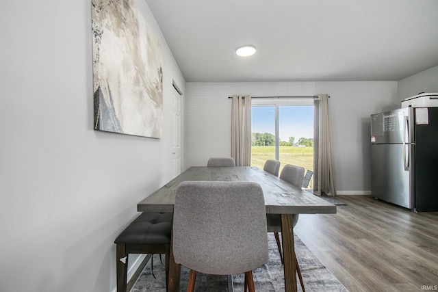 dining room featuring baseboards and wood finished floors