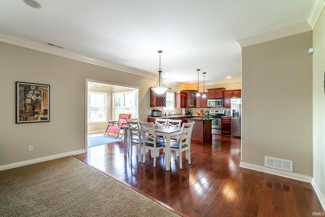 dining space featuring crown molding and dark hardwood / wood-style flooring