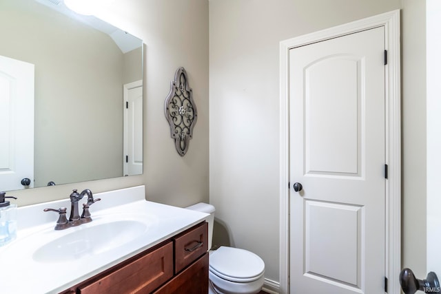 bathroom featuring toilet and vanity