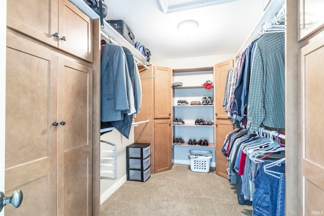 spacious closet featuring light carpet