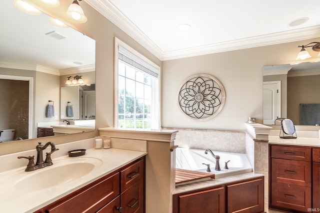 bathroom with tiled bath, crown molding, toilet, and vanity