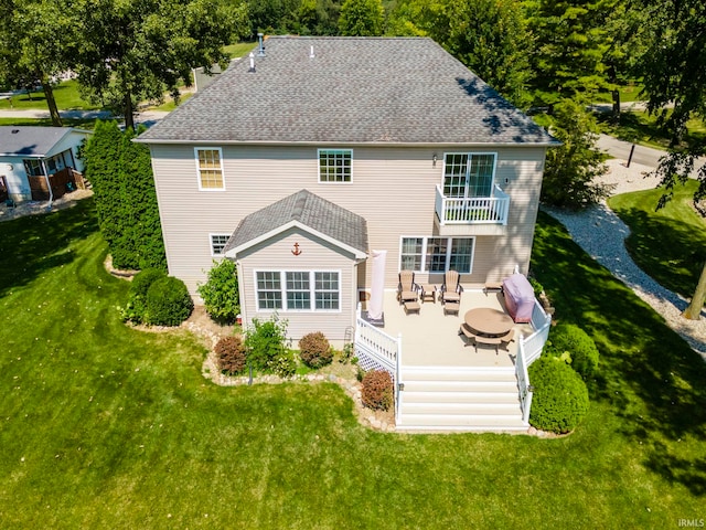 rear view of property featuring a deck and a yard