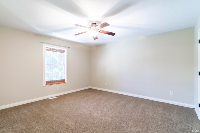 unfurnished room with ceiling fan and carpet floors