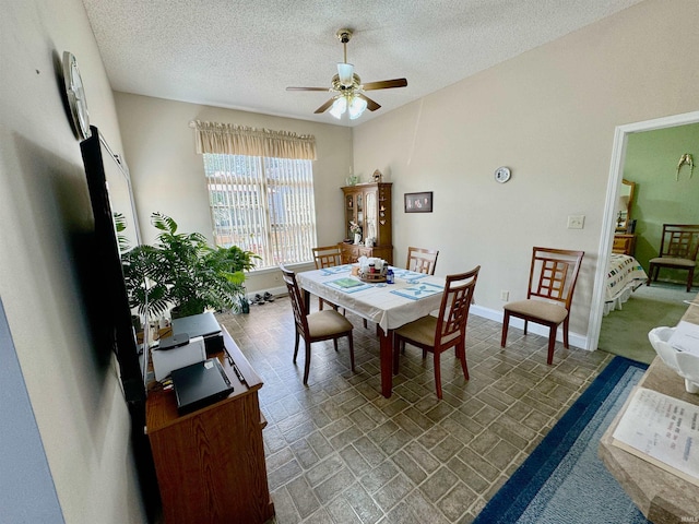 dining room featuring a textured ceiling and ceiling fan