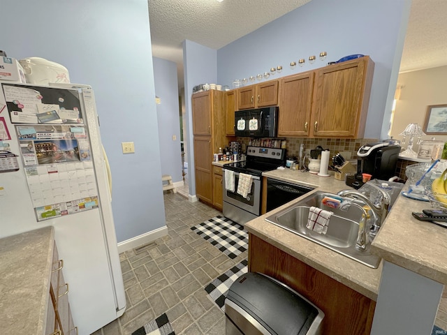 kitchen featuring a textured ceiling, a sink, light countertops, black appliances, and brown cabinetry