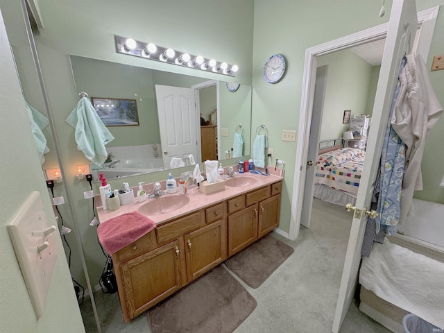 full bathroom with a sink, ensuite bath, and double vanity